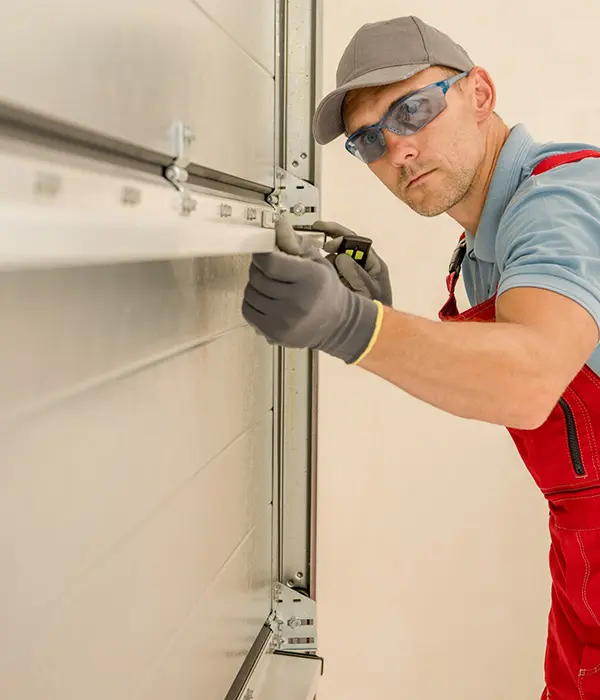 Man repairing garage door installation