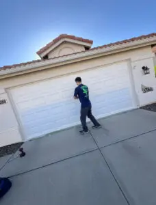 Person repairing residential garage door