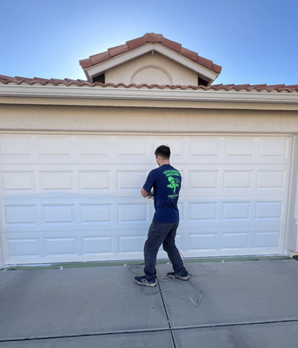Garage door painting service technician