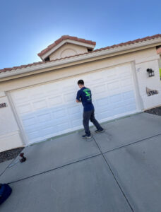 Person repairing residential garage door