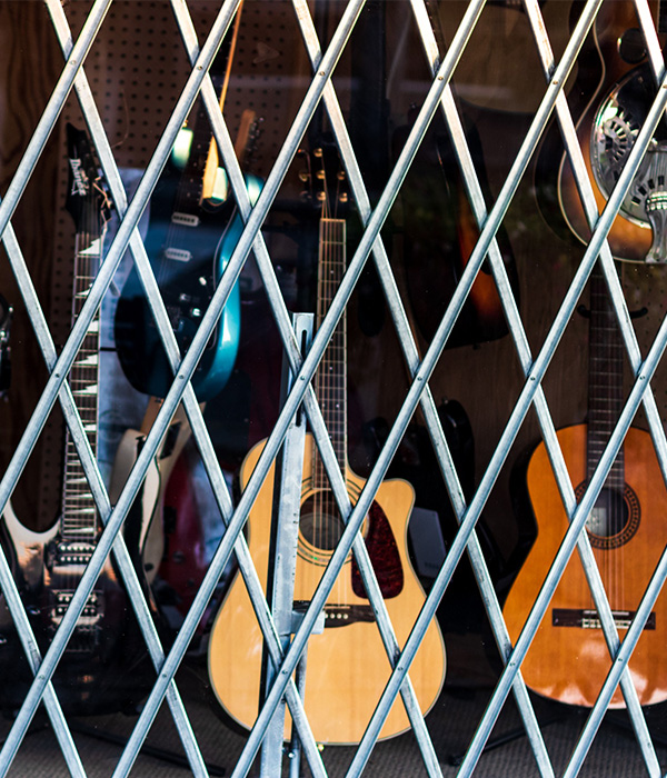 Guitars behind store security gate